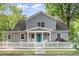 Charming two-story home with gray siding, white trim, and a welcoming front porch and a nice white picket fence at 219 Northwood Cir, Durham, NC 27701