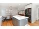 Open-concept kitchen boasts a large island, stainless steel appliances, and hardwood floors throughout the home at 219 Northwood Cir, Durham, NC 27701