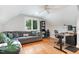 Cozy living room featuring a comfortable couch, hardwood floors, and a window with neighborhood views at 219 Northwood Cir, Durham, NC 27701