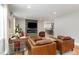 Cozy living room featuring a stone fireplace, hardwood floors, and an open concept layout adjacent to the kitchen at 219 Northwood Cir, Durham, NC 27701