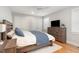 This primary bedroom offers a calm oasis, with a ceiling fan, hardwood floors, and ample natural light at 219 Northwood Cir, Durham, NC 27701