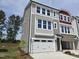 Charming three-story townhome with two car garage, neutral siding and an abundance of windows at 2201 Lambert Rd # 66, Cary, NC 27519