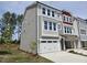 Charming three-story townhome with two car garage, neutral siding and an abundance of windows at 2201 Lambert Rd # 66, Cary, NC 27519