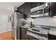 Modern kitchen showcasing stainless steel appliances, granite countertops, and ample cabinet space at 2202 Environ Way # Bldg 2000, Chapel Hill, NC 27517