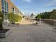 Spacious outdoor patio with tables and chairs, brick flooring, and a view of the surrounding trees at 2202 Environ Way # Bldg 2000, Chapel Hill, NC 27517