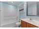 Clean bathroom featuring a tub, vanity, and storage; walls painted in a light blue at 2210 Raven Rd # 105, Raleigh, NC 27614