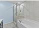 Bright bathroom featuring a separate glass enclosed shower and tub at 2210 Raven Rd # 105, Raleigh, NC 27614