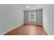 Cozy bedroom featuring hardwood floors, a ceiling fan, and a large window with natural light at 2210 Raven Rd # 105, Raleigh, NC 27614