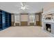 Spacious bedroom with a ceiling fan, fireplace, and built-in shelving at 2210 Raven Rd # 105, Raleigh, NC 27614