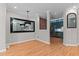Open floor plan with a sleek black mirror and an adjacent kitchen at 2210 Raven Rd # 105, Raleigh, NC 27614
