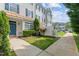 Charming townhouse with tidy front yard, landscaping, and welcoming blue door at 2210 Raven Rd # 105, Raleigh, NC 27614