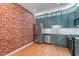 Modern kitchen features unique blue cabinetry and stainless steel appliances at 2210 Raven Rd # 105, Raleigh, NC 27614