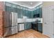Updated kitchen with blue cabinets, stainless steel appliances, and ample counter space at 2210 Raven Rd # 105, Raleigh, NC 27614