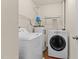 Functional laundry room with modern washer and dryer units, and efficient water heater at 2210 Raven Rd # 105, Raleigh, NC 27614