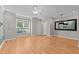 Bright living room boasting hardwood floors, a ceiling fan, and ample natural light at 2210 Raven Rd # 105, Raleigh, NC 27614
