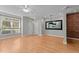Cozy living room with hardwood floors, a modern light fixture, and a large window at 2210 Raven Rd # 105, Raleigh, NC 27614