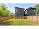 View of the backyard with a deck, wooden fence, and modern home exterior at 2325 Sheffield Rd # 102, Raleigh, NC 27610