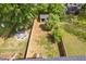 Aerial view of fenced backyard with a fire pit and storage shed in the rear at 2325 Sheffield Rd # 102, Raleigh, NC 27610
