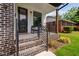 Cozy front porch with brick stairs, black railing and welcoming seating arrangement at 2325 Sheffield Rd # 102, Raleigh, NC 27610