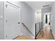 Upstairs hallway with modern railing and neutral color scheme at 2325 Sheffield Rd # 102, Raleigh, NC 27610