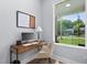 Bright home office space with wood desk, sleek computer, natural light, and neighborhood view at 2325 Sheffield Rd # 102, Raleigh, NC 27610