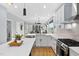 Open-concept kitchen featuring white cabinets, quartz countertops, stainless steel appliances, and island at 2325 Sheffield Rd # 102, Raleigh, NC 27610