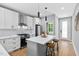 Stylish kitchen featuring white cabinetry, a center island, and modern appliances at 2325 Sheffield Rd # 102, Raleigh, NC 27610