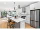 Modern white kitchen with stainless steel appliances and a center island at 2325 Sheffield Rd # 102, Raleigh, NC 27610