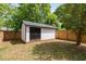 Outdoor shed with black doors and white siding in the spacious, fenced backyard at 2325 Sheffield Rd # 102, Raleigh, NC 27610