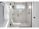 Modern tiled shower with glass door and rainfall shower head at 2325 Sheffield Rd # 102, Raleigh, NC 27610