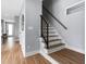 Modern staircase with wood treads and black metal railing at 2325 Sheffield Rd # 102, Raleigh, NC 27610