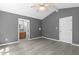 Bedroom features hardwood flooring, gray walls, vaulted ceiling, and an ensuite bathroom at 2402 Cynthia Dr, Durham, NC 27704