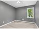 Bedroom featuring hardwood flooring, gray walls, and a window with treeline views at 2402 Cynthia Dr, Durham, NC 27704