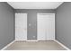 Spacious bedroom features hardwood flooring, neutral gray walls, and white doors at 2402 Cynthia Dr, Durham, NC 27704