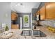 Well lit kitchen featuring granite countertops, stainless appliances, and wooden cabinets at 2402 Cynthia Dr, Durham, NC 27704