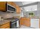 Modern kitchen featuring granite countertops and stainless steel appliances with an open floorplan at 2402 Cynthia Dr, Durham, NC 27704