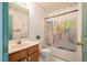 Charming bathroom with a world map shower curtain, complemented by a wooden vanity and ample natural light at 244 Sweet Bay Pl, Carrboro, NC 27510
