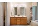 Bathroom featuring dual sinks with a wood vanity and an enclosed shower at 244 Sweet Bay Pl, Carrboro, NC 27510
