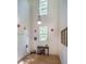 Inviting foyer featuring a high ceiling, a console table, and a striking white door at 244 Sweet Bay Pl, Carrboro, NC 27510