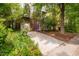A charming home featuring a convenient driveway leading to an attached garage with landscaped foliage at 244 Sweet Bay Pl, Carrboro, NC 27510