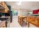 Eat-in kitchen features a wood table, black appliances, and a view to the backyard at 244 Sweet Bay Pl, Carrboro, NC 27510