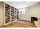 Cozy living room with fireplace, wood floors, and built-in bookshelves for ample storage and display space at 244 Sweet Bay Pl, Carrboro, NC 27510