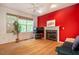 Living room features fireplace, hardwood floors, large window and bright red walls at 244 Sweet Bay Pl, Carrboro, NC 27510