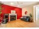 Cozy living room with fireplace, hardwood floors, and bright red accent wall at 244 Sweet Bay Pl, Carrboro, NC 27510