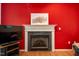 Living room features fireplace, hardwood floors, and bright red walls at 244 Sweet Bay Pl, Carrboro, NC 27510