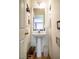 A half bath featuring a pedestal sink with a white frame mirror and neutral walls at 244 Sweet Bay Pl, Carrboro, NC 27510