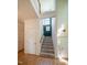 Carpeted staircase with white trim and wooden handrail at 244 Sweet Bay Pl, Carrboro, NC 27510