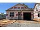 New construction home featuring an attached garage and bright window, awaiting personalization and finishing touches at 245 Bluejay St, Clayton, NC 27520