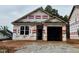 New construction home with a two-car garage and covered entry awaiting its finishing touches at 245 Bluejay St, Clayton, NC 27520