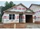 Front exterior of a home under construction with visible framing and HomeGuard branded weather-resistant barriers at 245 Bluejay St, Clayton, NC 27520